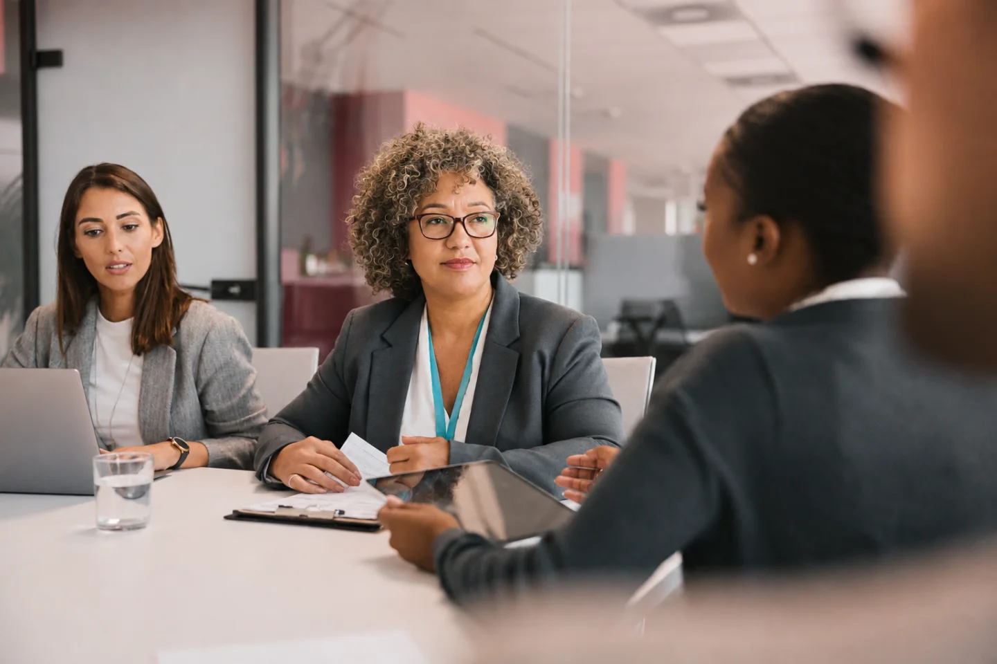 Professionals discussing documents during a meeting.